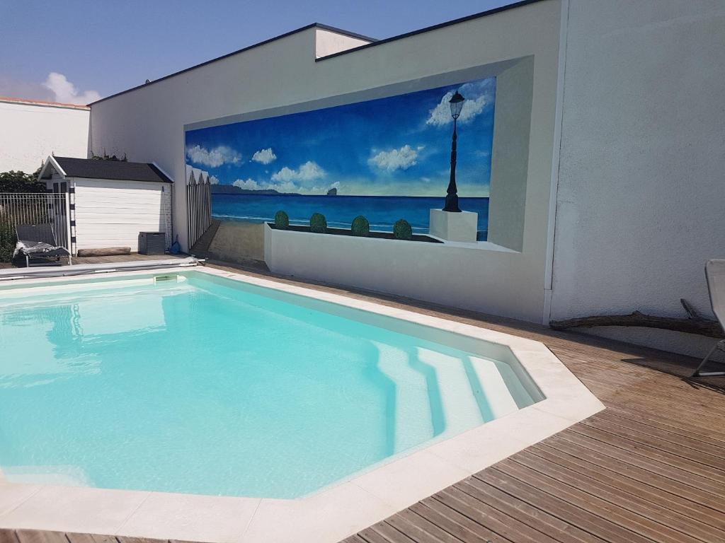 a swimming pool with a view of the ocean at Appart Madame à Chatelaillon plage 2 pers in Châtelaillon-Plage