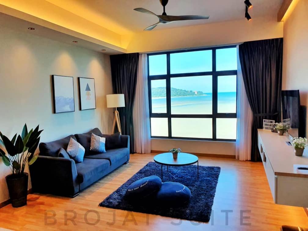 a living room with a couch and a table at Brojat Suite Family Sea View @ Imperium Residence in Kuantan