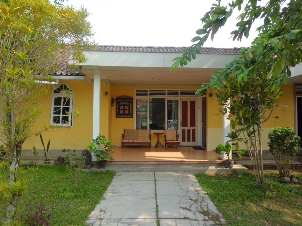 a yellow house with a patio at Efata Homestay in Borobudur