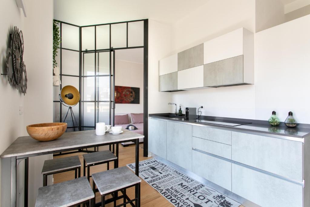 ボルツァーノにあるDolomiti 65 mq new flat in the center of Bolzanoのキッチン(カウンター、テーブル、椅子付)