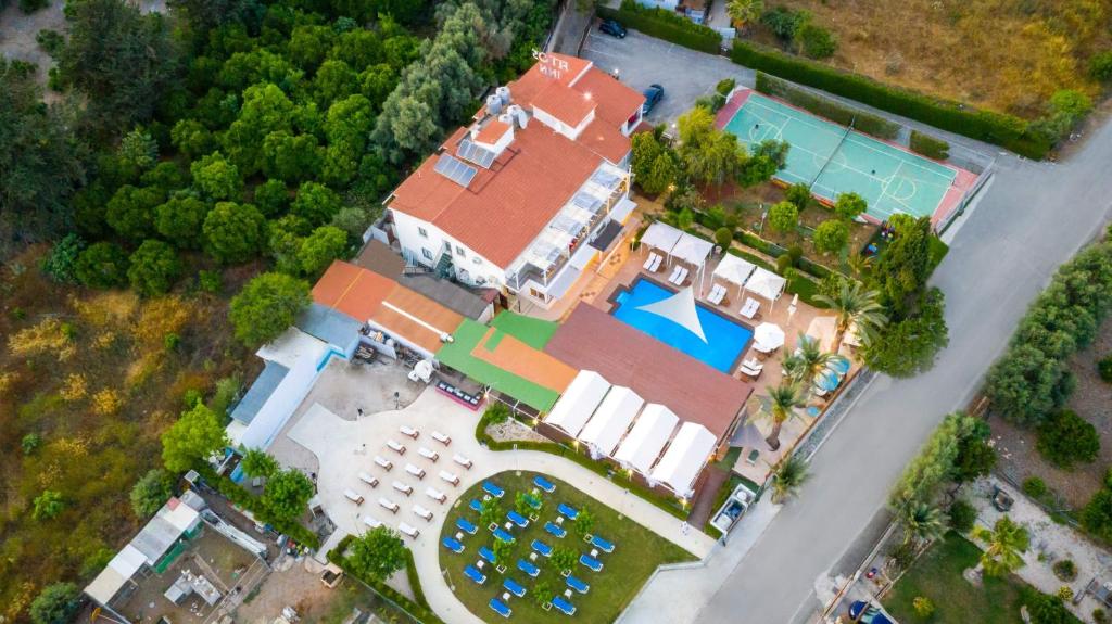 an overhead view of a large house with a swimming pool at Fitosinn Hotel in Paphos City