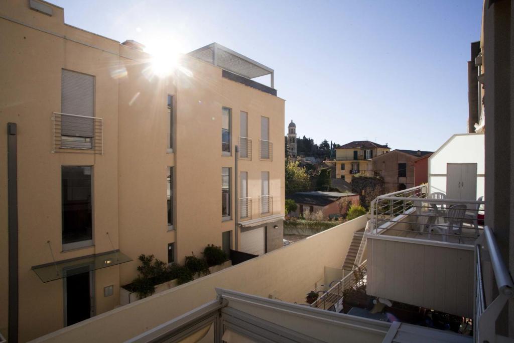 a balcony of a building with the sun shining on it at Camere e case vacanza Residenza Prealba in Levanto