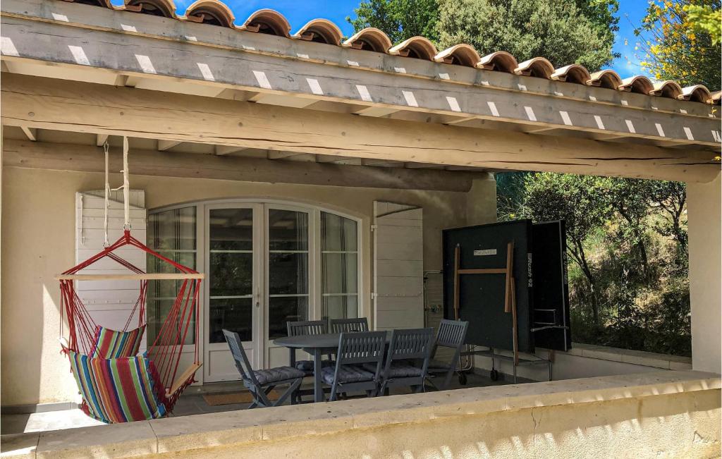 a patio with chairs and a table on a porch at Le Clos De Rosa in Crillon-le-Brave