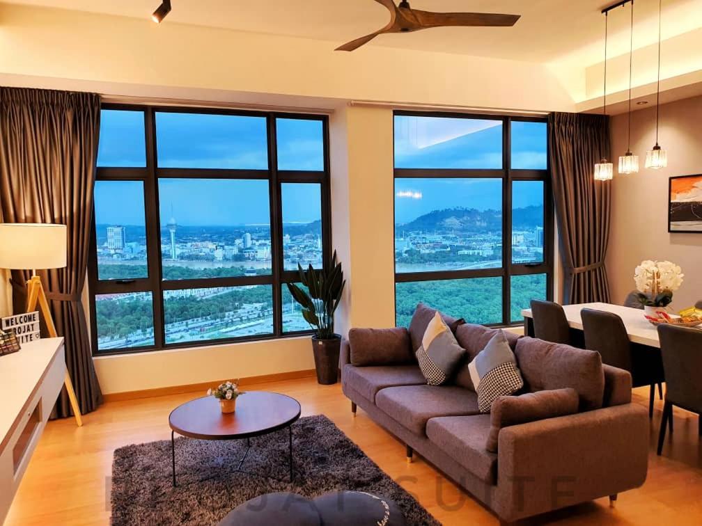 a living room with a couch and large windows at Brojat Suite Family City View @ Imperium Residence in Kuantan