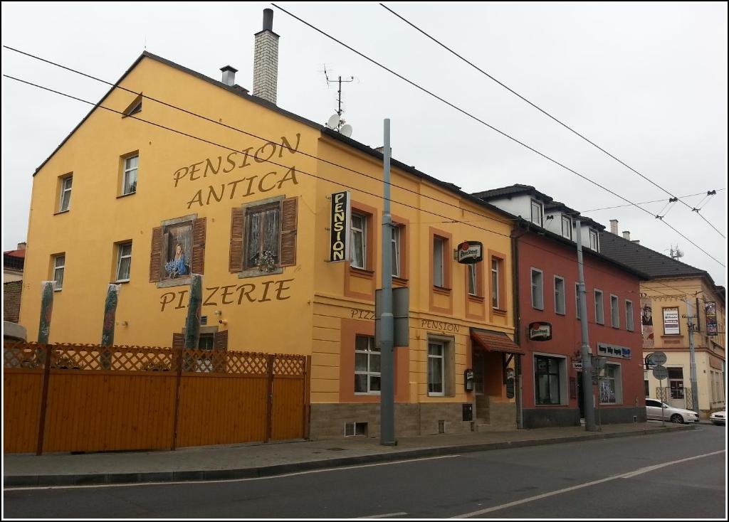 a yellow building on the side of a street at Pension Antica in Pilsen