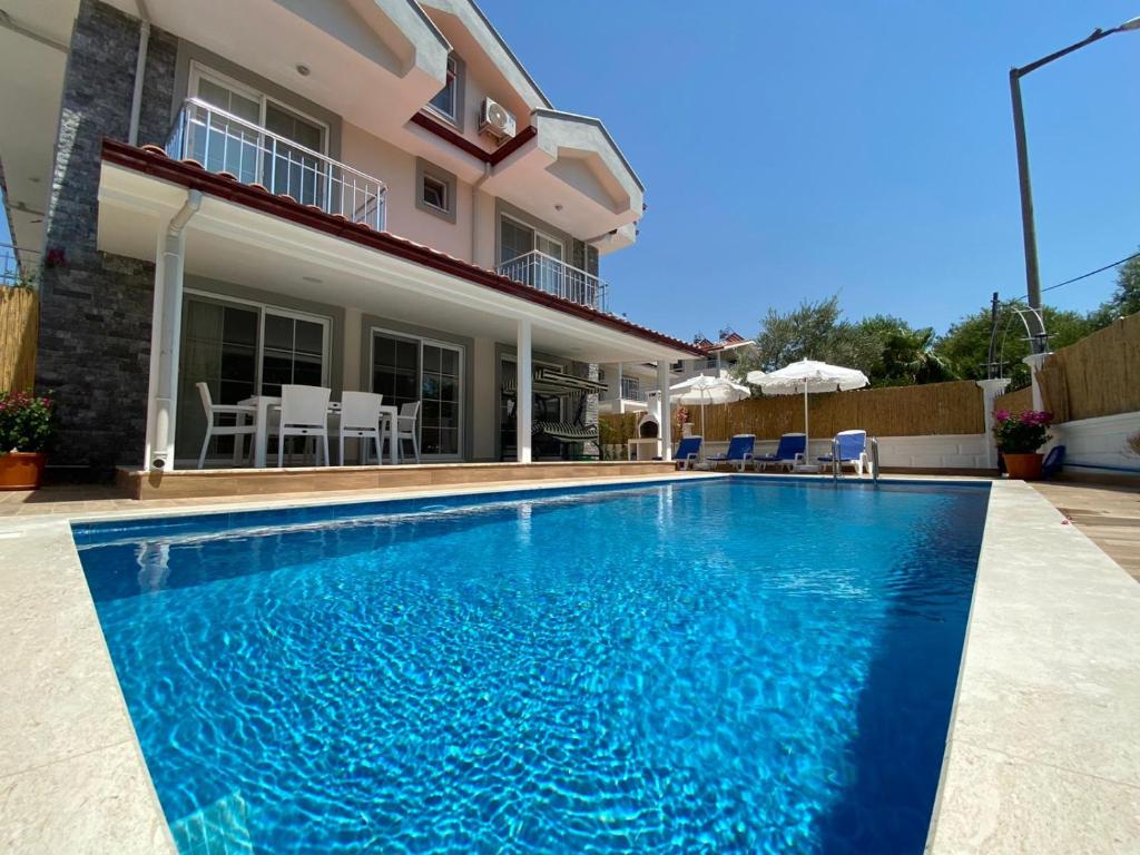 a swimming pool in front of a house at Villa Sunrise in Dalyan