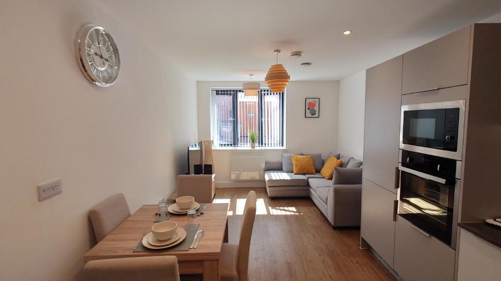 a living room with a table and a couch at Treasured 1 Bedroom Jewellery Quarter Apartment in Birmingham