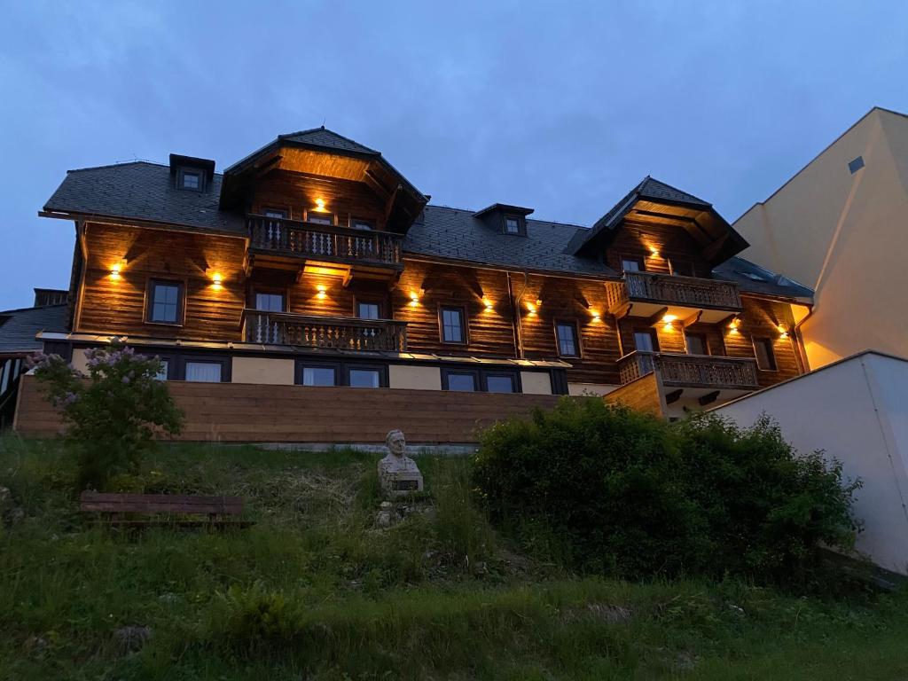 a large wooden house with lights on it at Alpl Resort in Krieglach