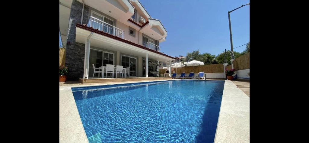 a swimming pool in front of a house at Villa Sunset in Dalyan