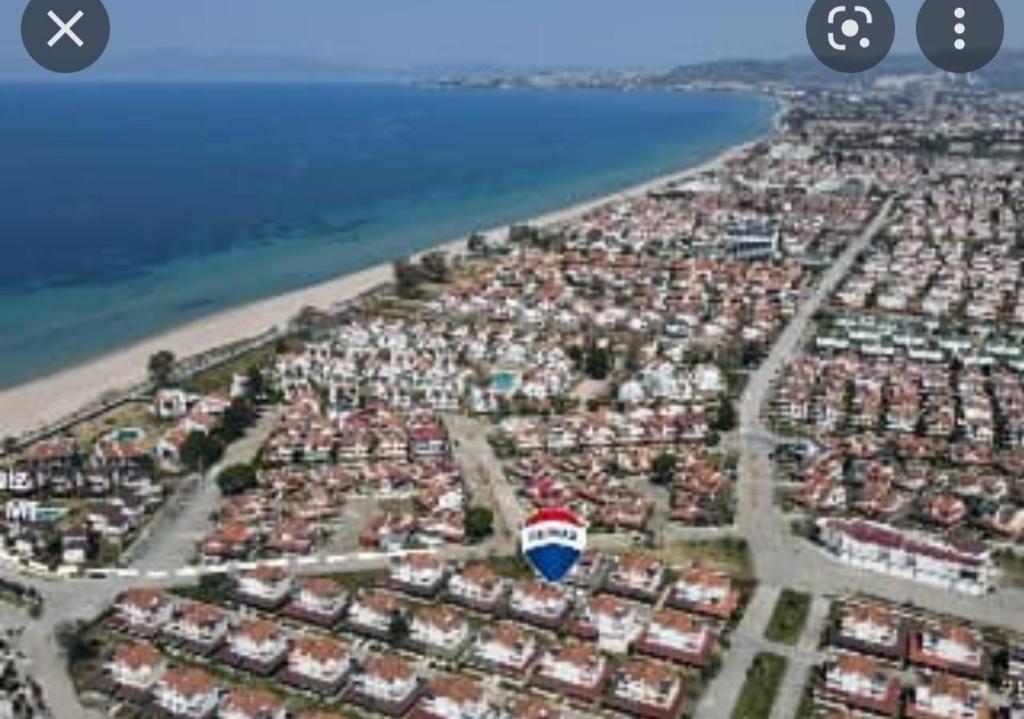 an aerial view of a city with houses and the ocean at Villa in Kuşadası