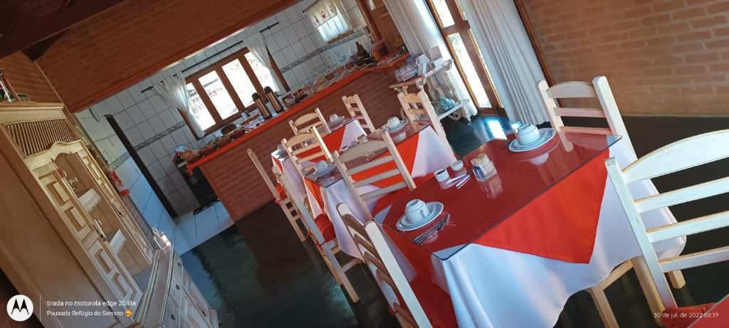 an overhead view of a kitchen with a red table and chairs at Pousada Refugio do Serrano in São Bento do Sapucaí