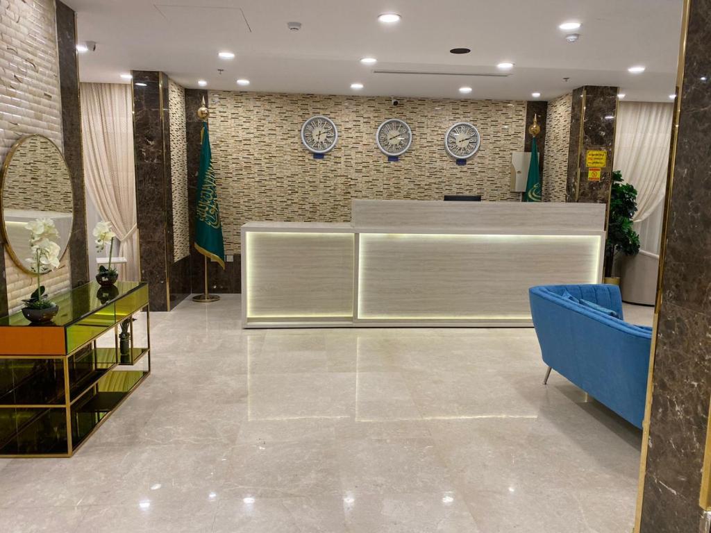 a lobby with a reception desk in a building at Taj Al Eiman Hotel in Al Madinah