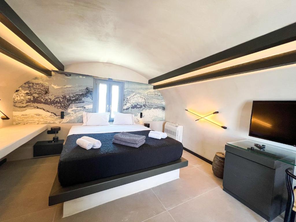 Postel nebo postele na pokoji v ubytování ArmonOia Suites