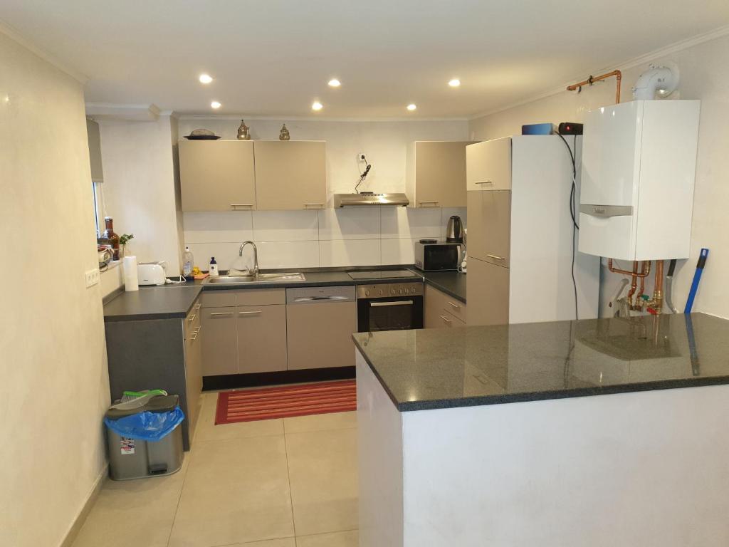 a kitchen with a refrigerator and a counter top at Sehr grosse 5 Zimmer Wohnung mit Garten und terasse in Wiesbaden