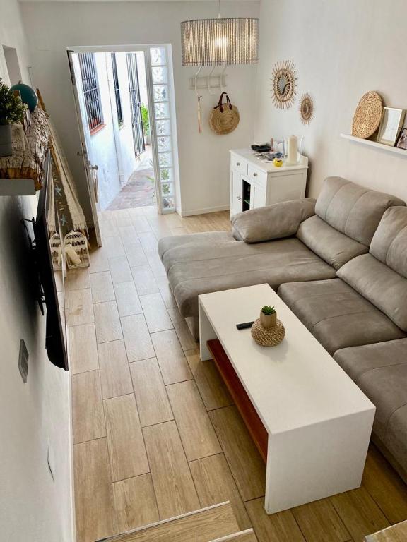 a living room with a couch and a coffee table at La casita de Lú in Casares
