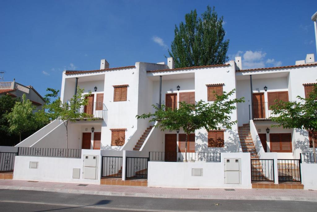a white building on the side of a street at TEPINSA · Alquiler de Apartamentos in Torreblanca