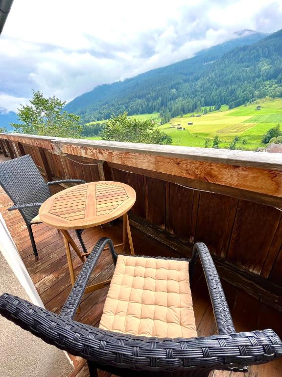 a chair and a table on a balcony with a view at Pranger Hof in Trins