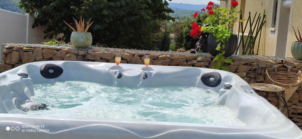 a white bath tub with two candles in it at Campagne et Jacuzzi ... c'est cosy le Bumble Bee ! in Panossas