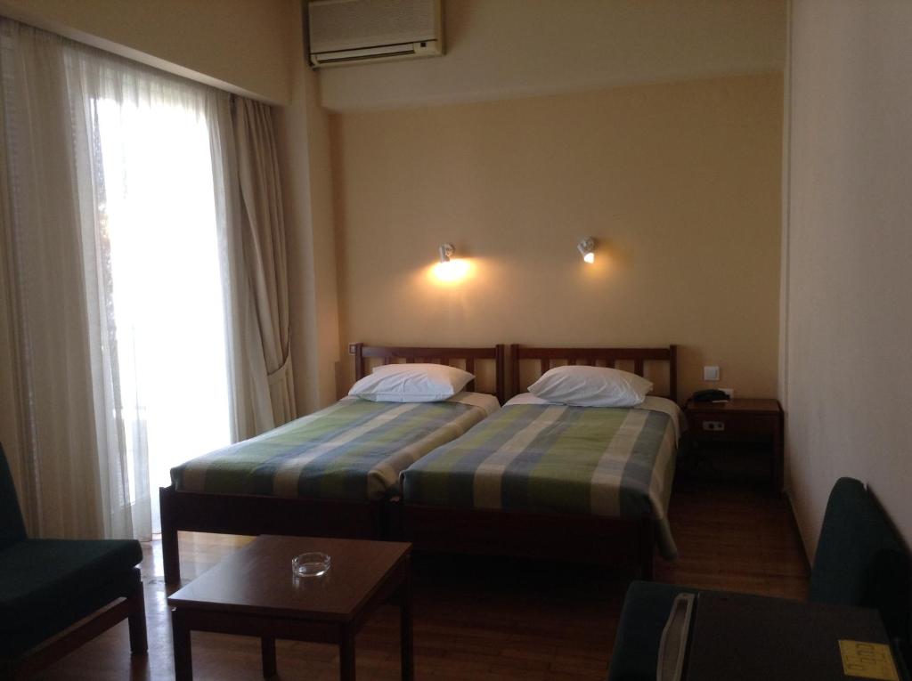 Postel nebo postele na pokoji v ubytování Hotel Alexandros
