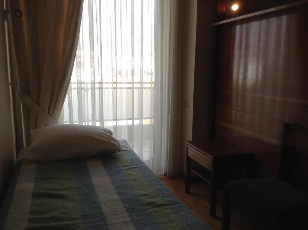 Postel nebo postele na pokoji v ubytování Hotel Alexandros