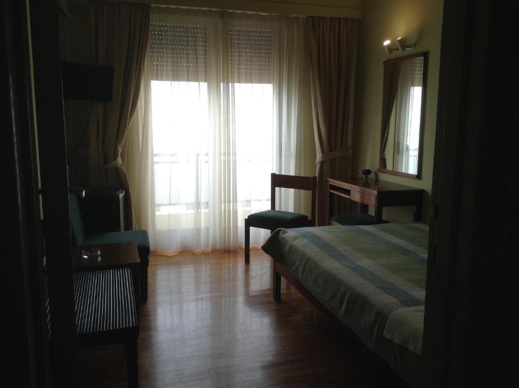 Postel nebo postele na pokoji v ubytování Hotel Alexandros