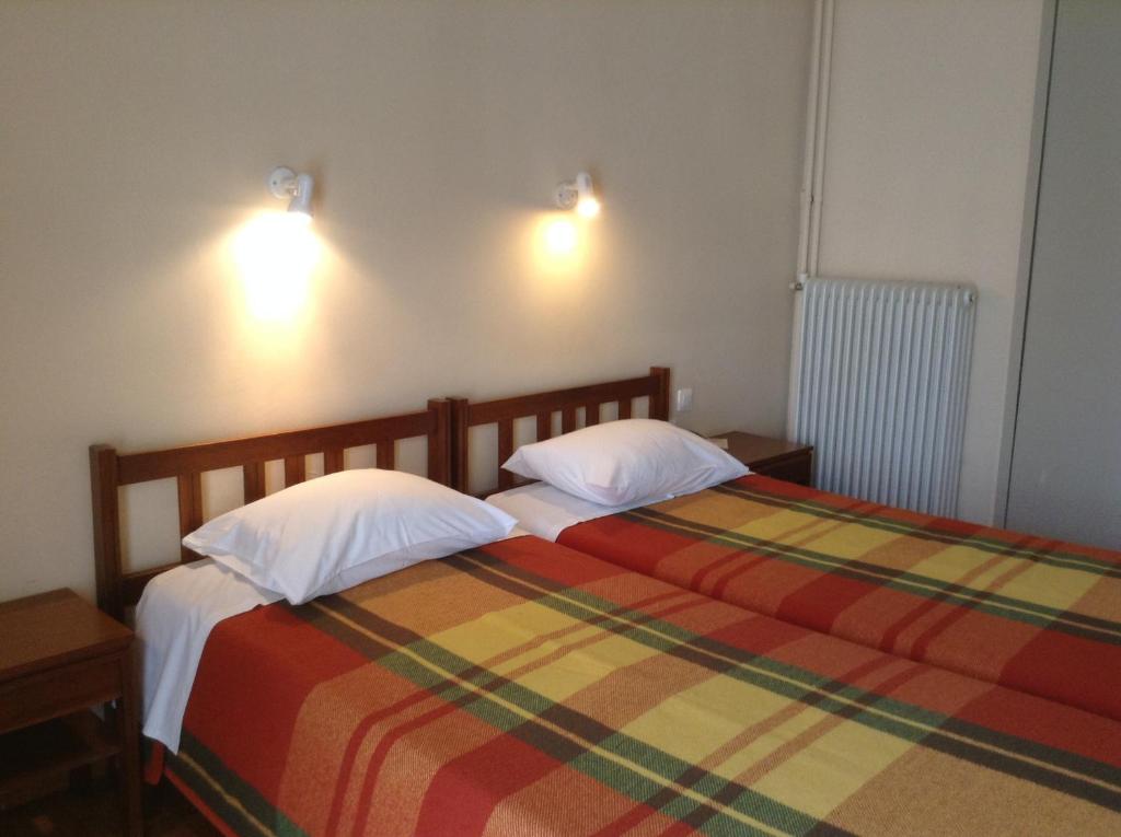 Postel nebo postele na pokoji v ubytování Hotel Alexandros