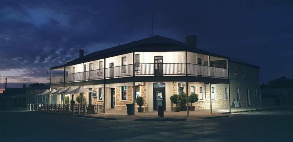 a large white building with a balcony on top of it at Cornwall Hotel in Moonta