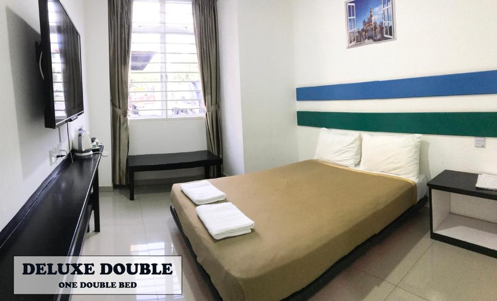 Postel nebo postele na pokoji v ubytování JERANTUT HILL HOTEL