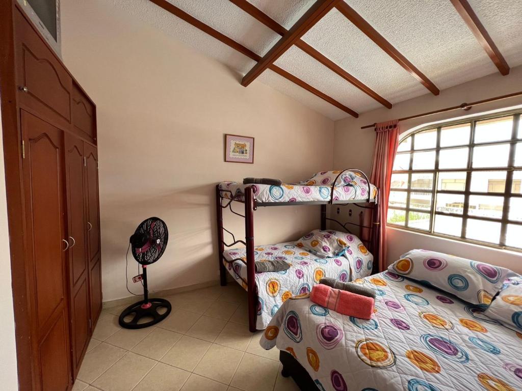 a bedroom with two bunk beds and a window at Anapoima -Liberia in Anapoima
