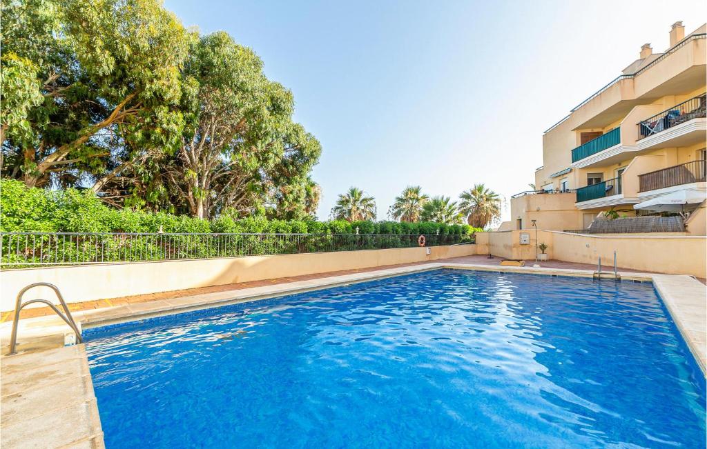 a swimming pool in front of a building at 1 Bedroom Gorgeous Apartment In Roquetas De Mar in Roquetas de Mar