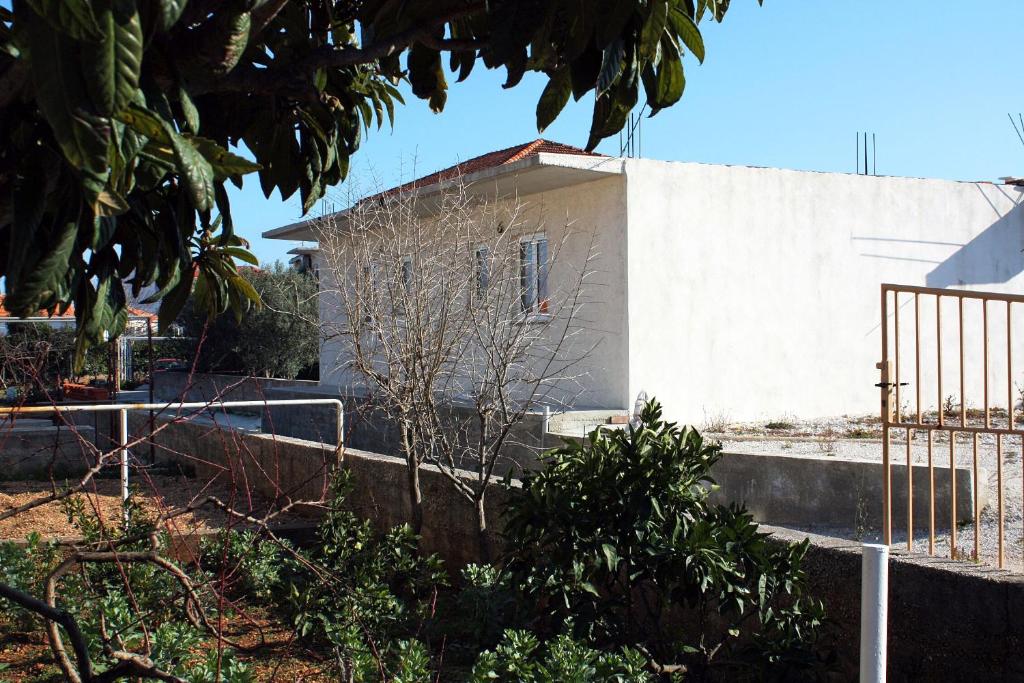 a white building with a fence in front of it at Apartments by the sea Slatine, Ciovo - 4844 in Slatine