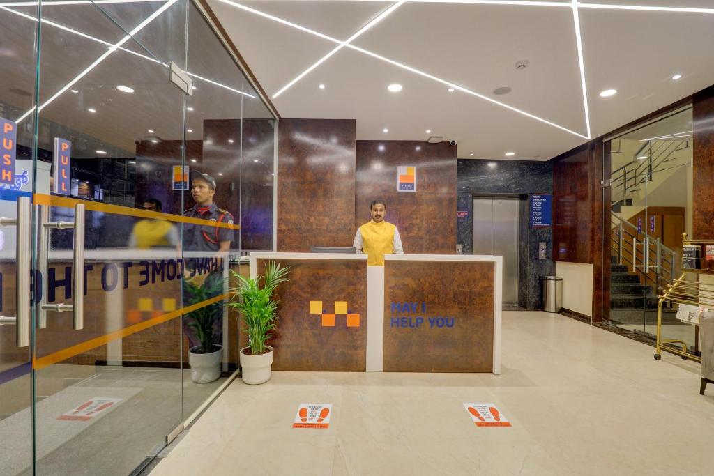 a man standing at a counter in a building at MySpace Tattwa Grand in Yelahanka