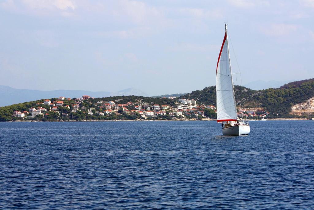 a sailboat on a large body of water at Apartment Okrug Donji 16657b in Okrug Donji