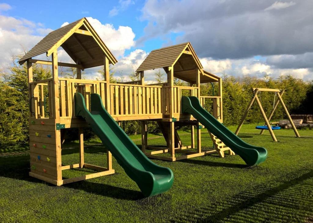 two playground equipment with slides in a park at Kings Lynn Holiday Park in King's Lynn