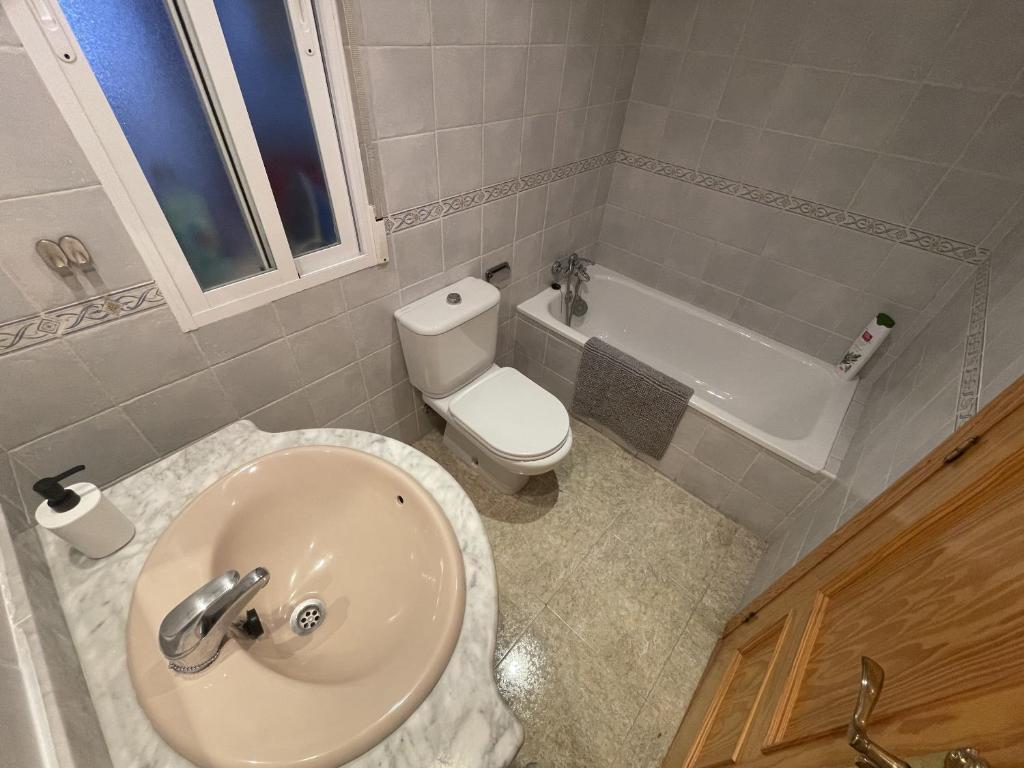 łazienka z umywalką, toaletą i wanną w obiekcie Sunny 3 bed apartment only 7 minute walk from beac w mieście La Herradura