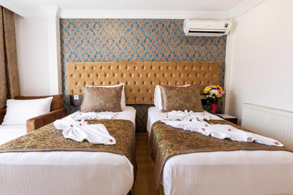 Postel nebo postele na pokoji v ubytování Kumru Hotel