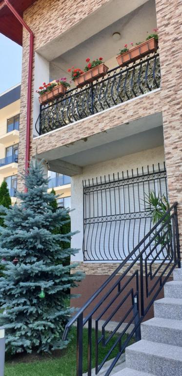 a christmas tree on the balcony of a building with a christmas tree at D&H in Năvodari