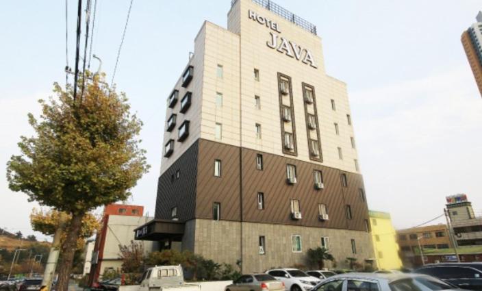 a building with a sign on the side of it at Java Hotel in Gwangyang