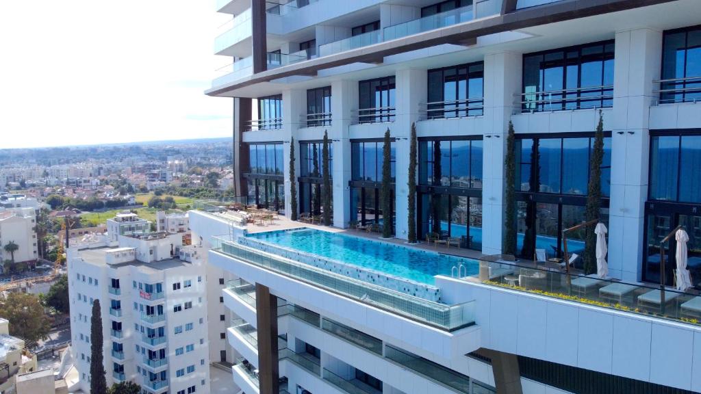 a swimming pool on the side of a building at Luxury Private Apartments - Limassol in Limassol