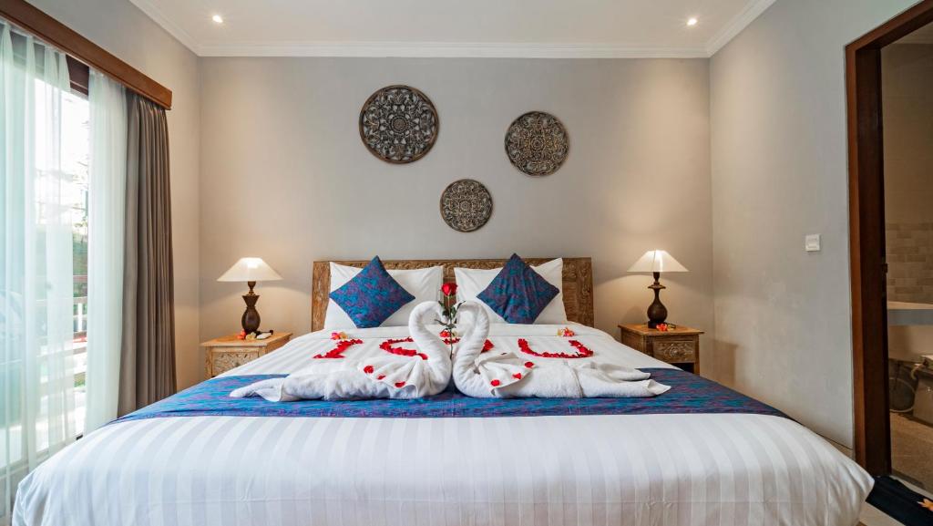 Postel nebo postele na pokoji v ubytování Ayu Sari Guesthouse by Mahaputra
