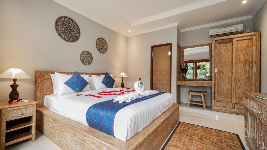 Postel nebo postele na pokoji v ubytování Ayu Sari Guesthouse by Mahaputra