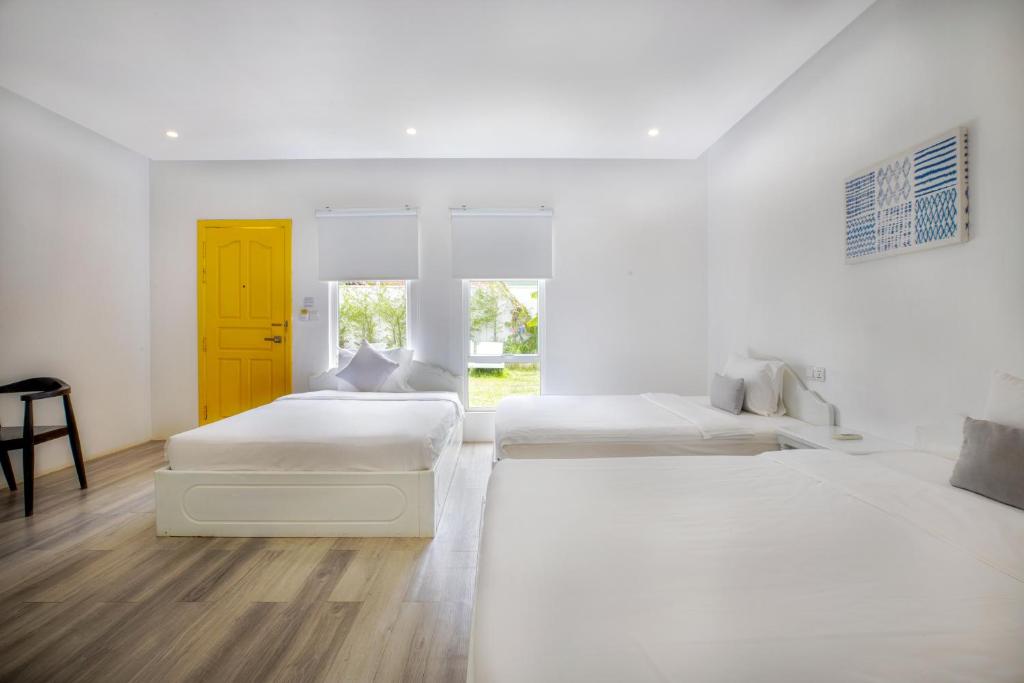 Postel nebo postele na pokoji v ubytování Glow Inn Siem Reap