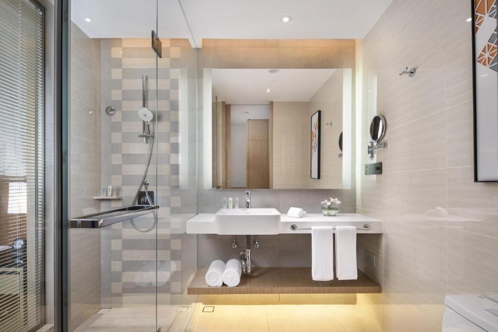 a bathroom with a sink and a mirror at Holiday Inn Shaoguan Downtown, an IHG Hotel in Shaoguan