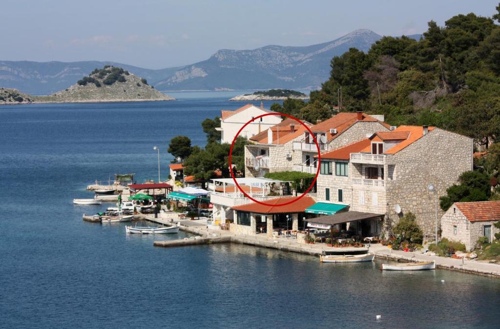 a group of boats docked in the water near a resort at Double Room Pomena 4929a in Pomena