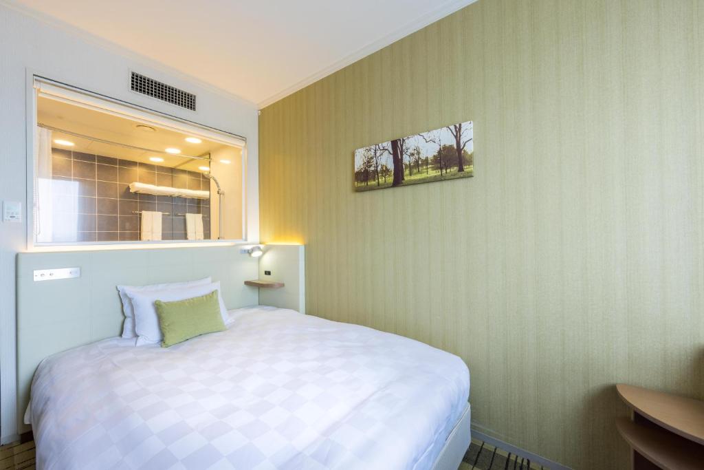 Postel nebo postele na pokoji v ubytování Kichijoji Excel Hotel Tokyu