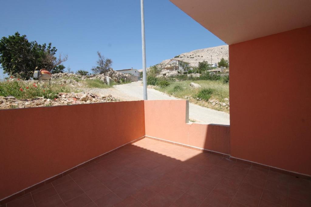 a room with an orange wall and a view of a road at Double Room Metajna 6487d in Metajna