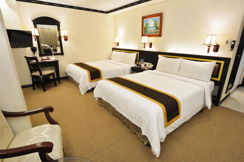 Postel nebo postele na pokoji v ubytování Bayview Park Hotel Manila