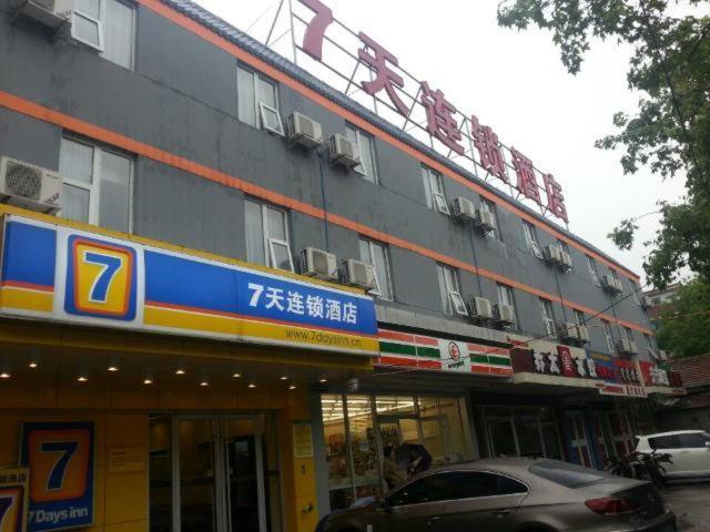 un edificio con un coche aparcado delante de él en 7Days Inn Railway Station Wulukou Subway Station en Xi'an