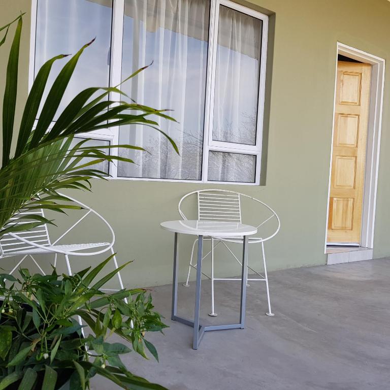 a table and chair in front of a window at Entsabeni Cottage in Big Bend