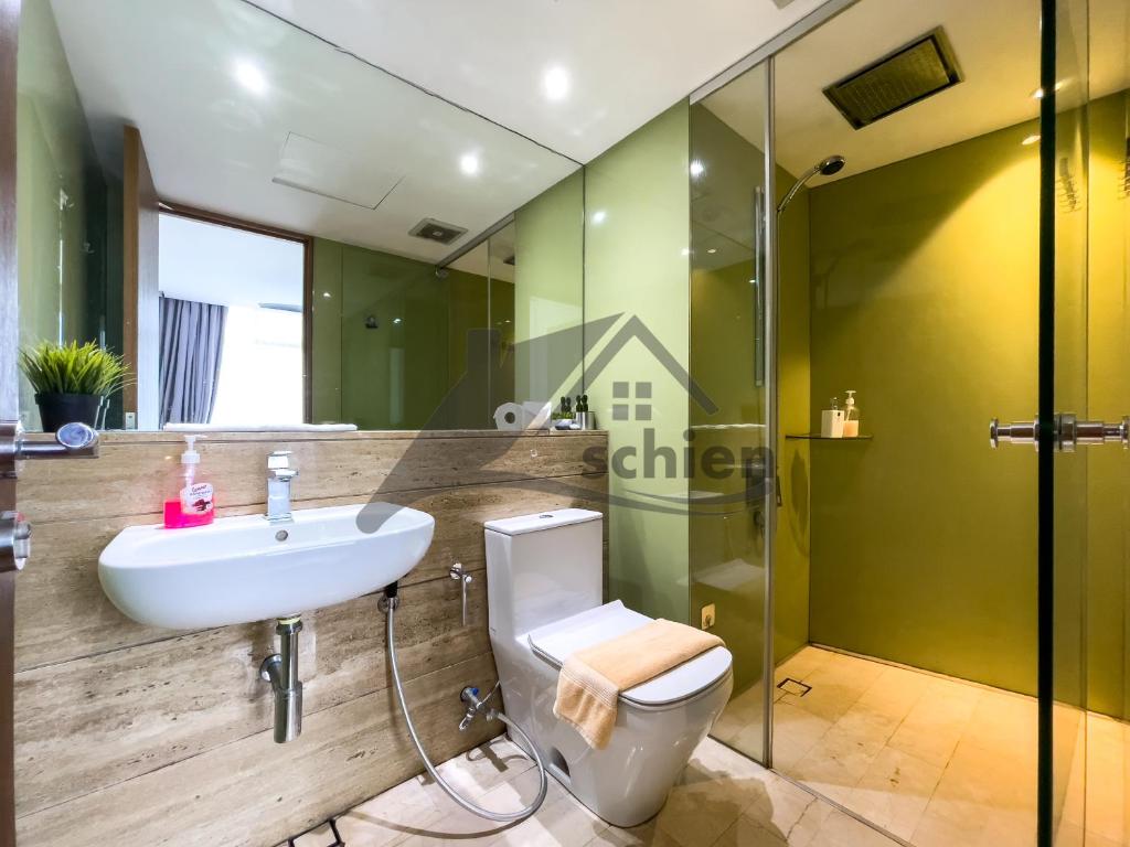 a bathroom with a sink and a toilet and a shower at Vortex Premium Suites KLCC by SCHIEN in Kuala Lumpur